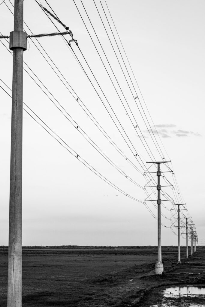 Black and white image of power lines stretching across the landscape in Hudson, Buenos Aires Province.